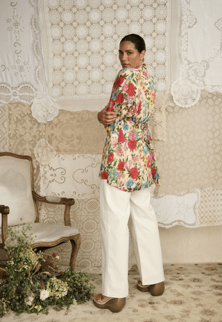 back-view-of-valley-of-the-dolls-short-robe-in-opal-floral-tencel-lyocell-with-self-belt-styled-with-white-wide-leg-pants