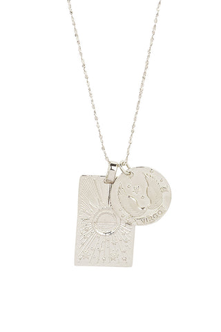 close-up-front-view-of-spell-s-virgo-stargazer-zodiac-necklace-charms-one-charm-is-of-a-rectangular-shape-and-features-a-sun-with-stars-while-the-other-charm-is-circular-and-features-the-zodiac-label-and-icon